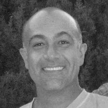Moti2-headshot A black and white photo of a man smiling.